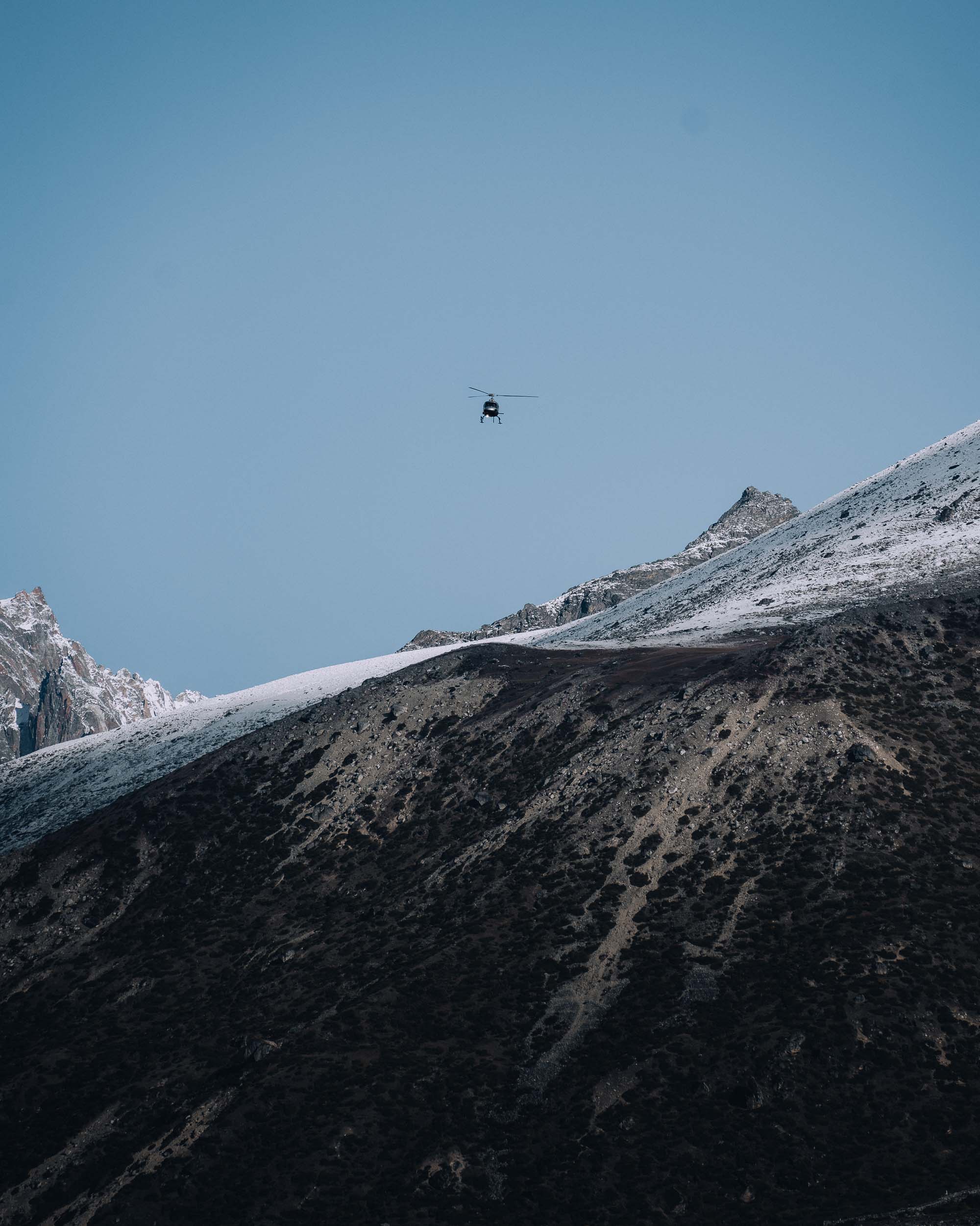 Helicopter in huge mountain landscapes
