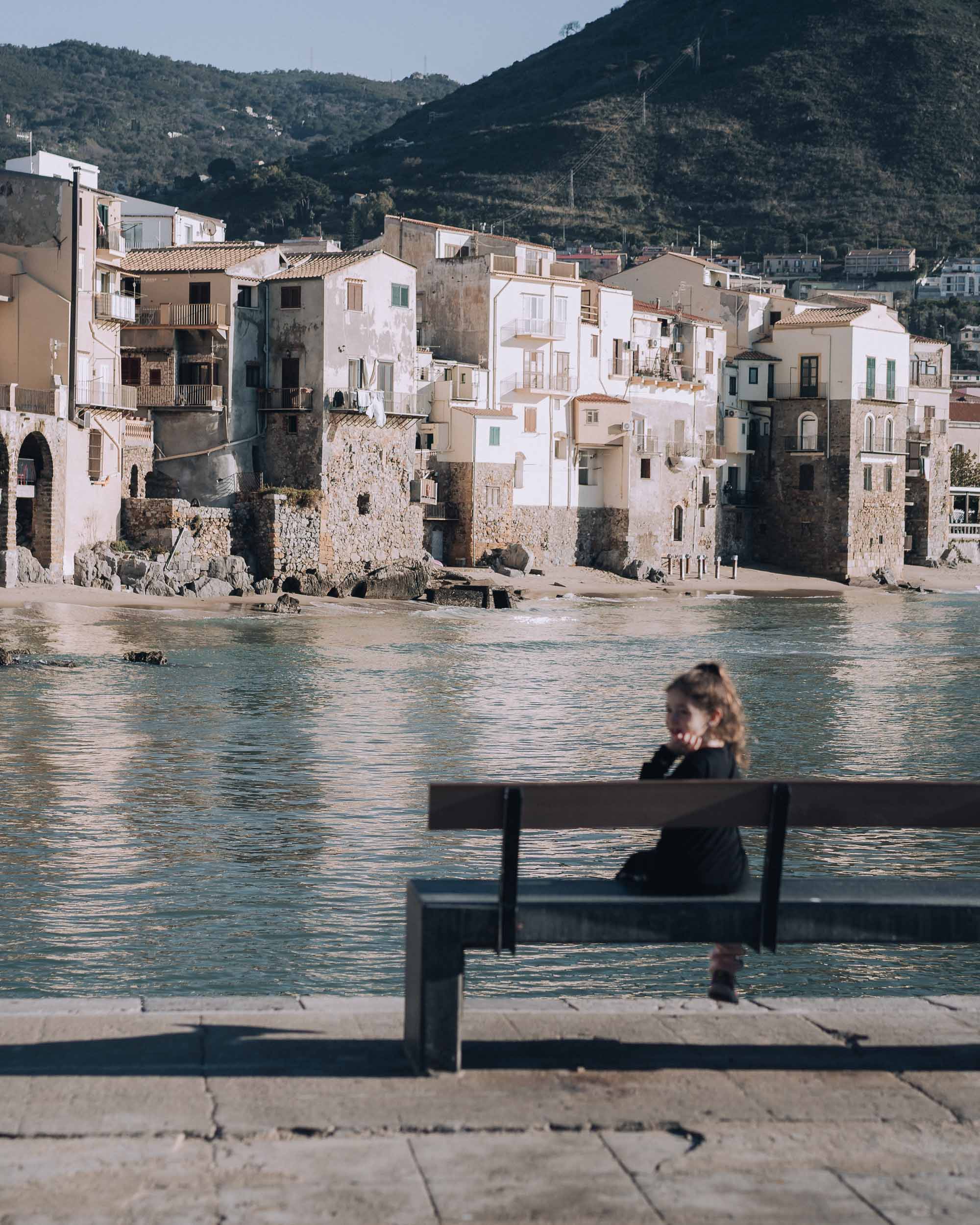 Child watching the sunset in Cefalu