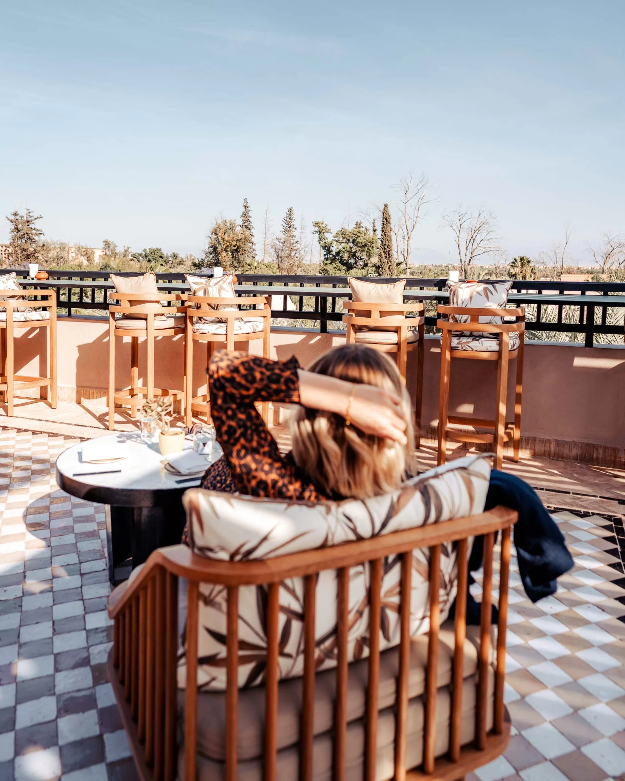 FourSeasons13 Woman relaxing at rooftop bar